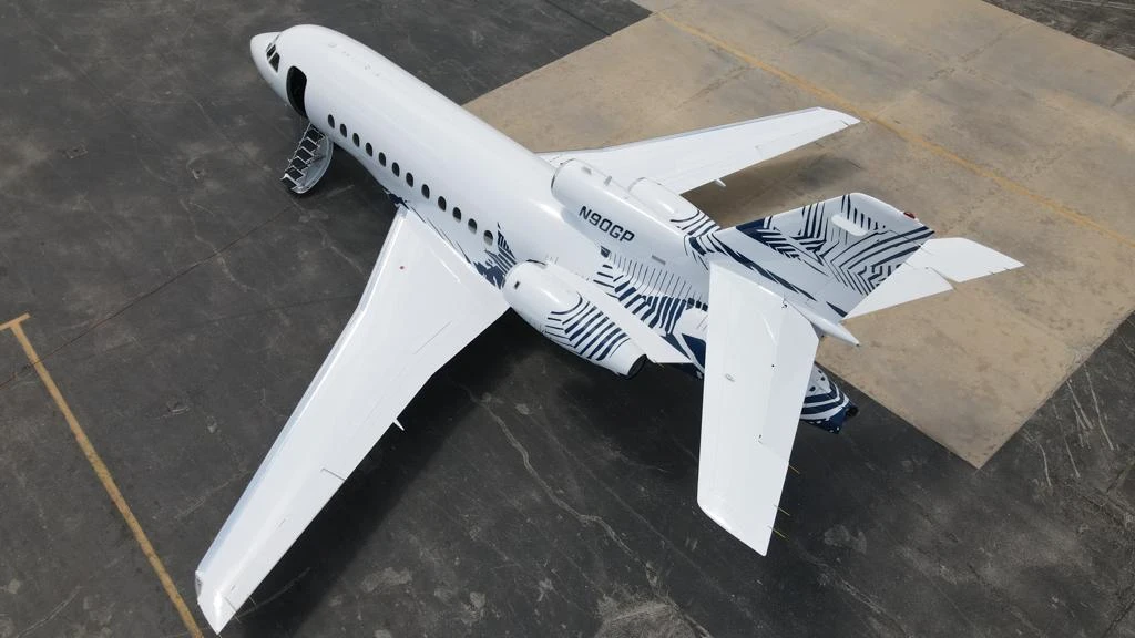 Vista superior de la obra azul y blanca sobre la aeronave Falcon 900
